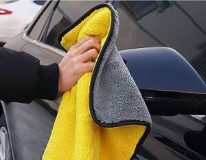 Car cleansing Towel | A man cleaning car with a microfiber